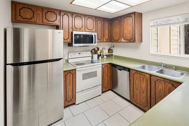 a kitchen with a sink window and cabinets