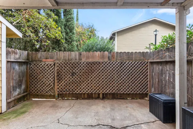 a view of a house with large windows and a small yard