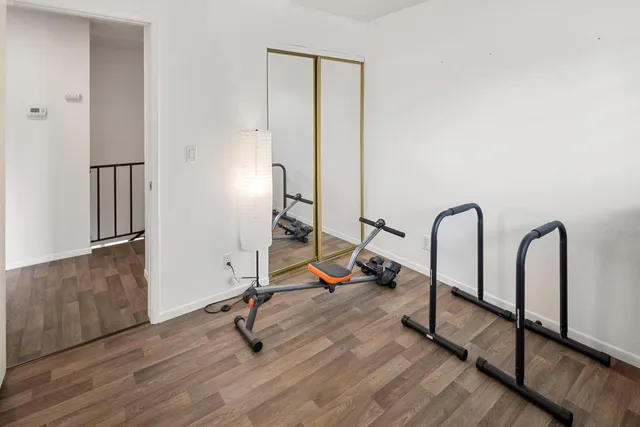 a view of a house with wooden fence next to a yard