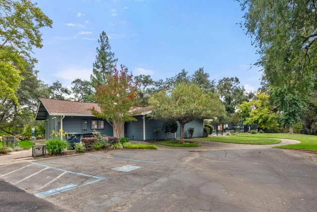 a view of house with swimming pool and sitting area