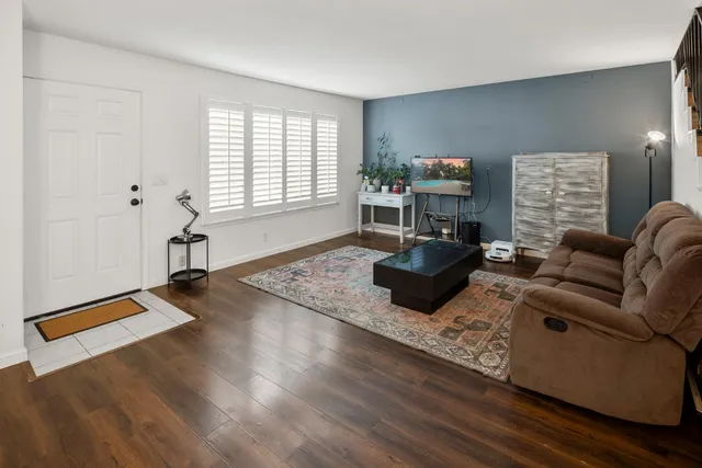 a living room with furniture and stairs