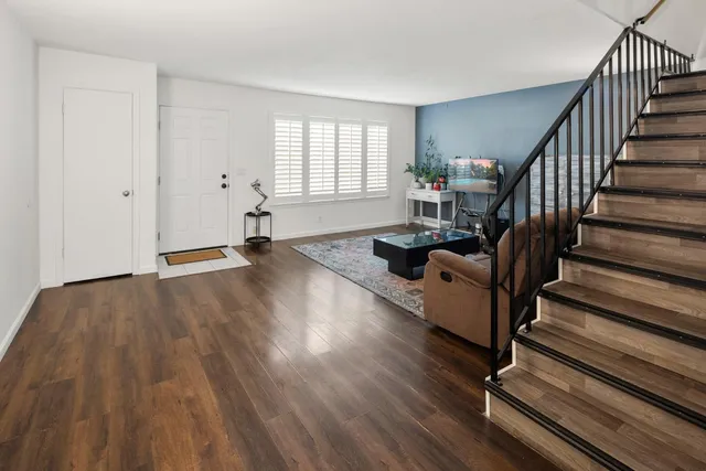 a view of staircase with white walls and railing