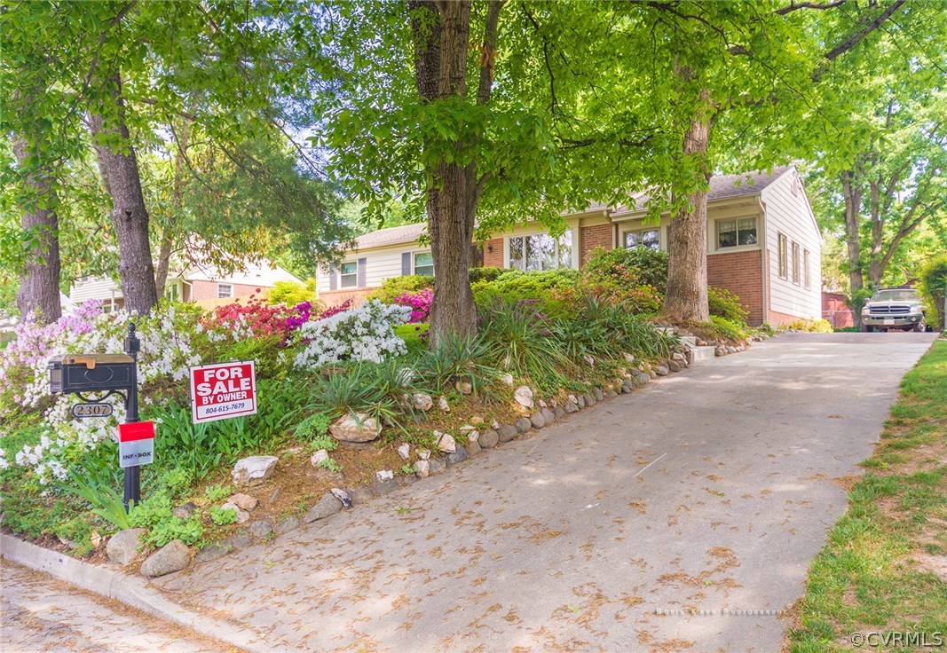 a sign that is sitting in front of flowers
