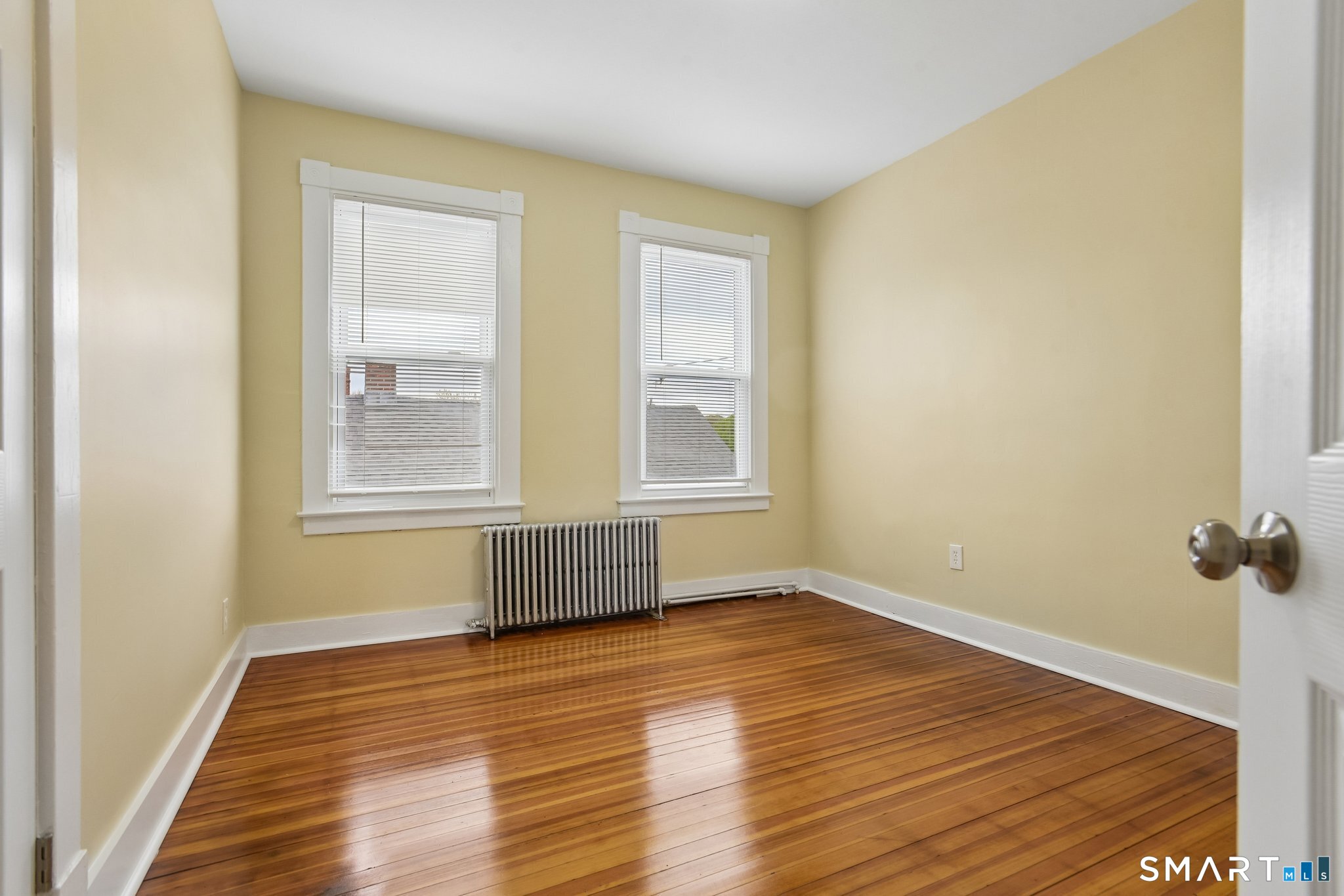 39 Grand Street, Unit 3 Middletown, CT 06457 - Photo 17 of 21 a view of an empty room with wooden floor and a window