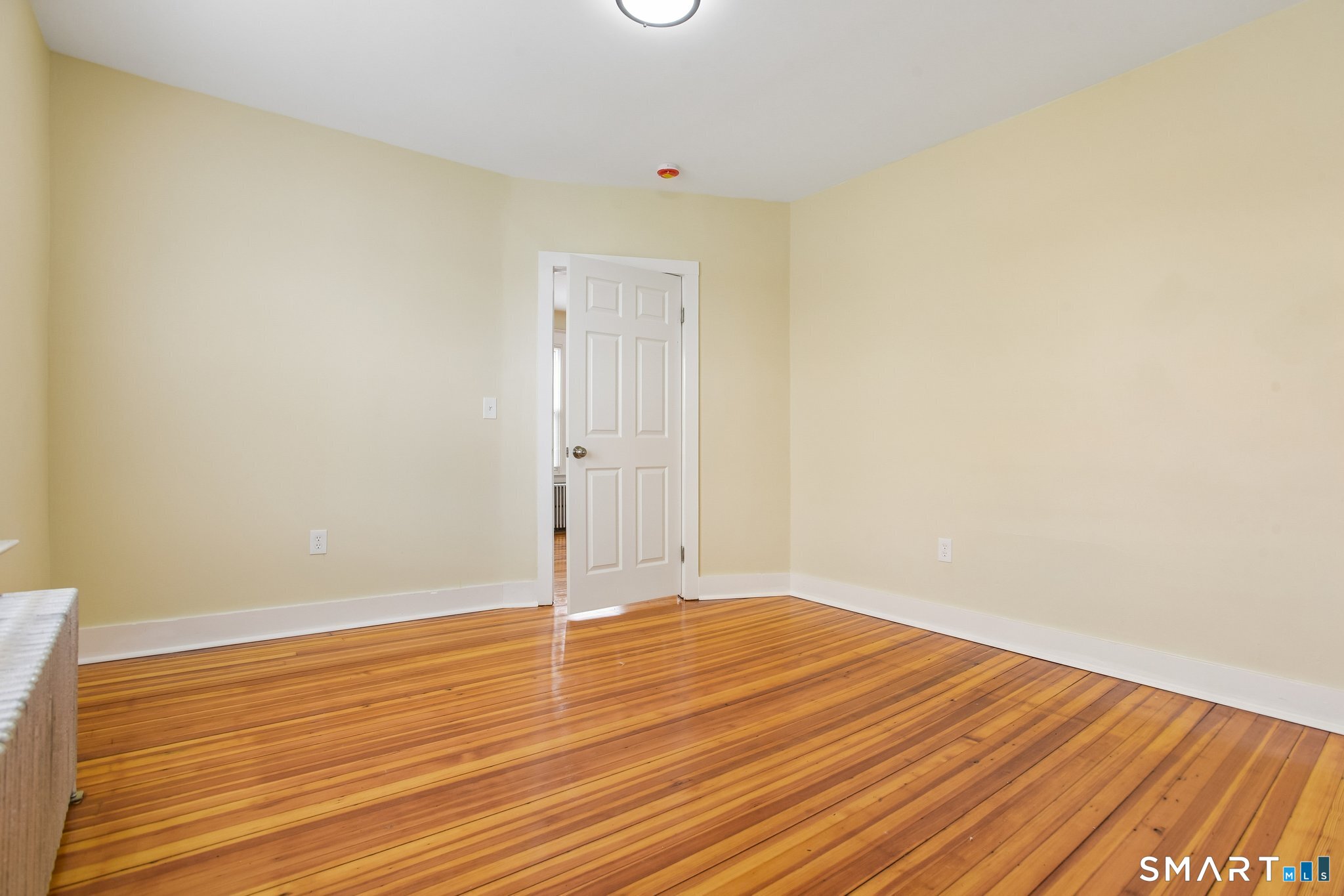 39 Grand Street, Unit 3 Middletown, CT 06457 - Photo 18 of 21 a view of an empty room with wooden floor