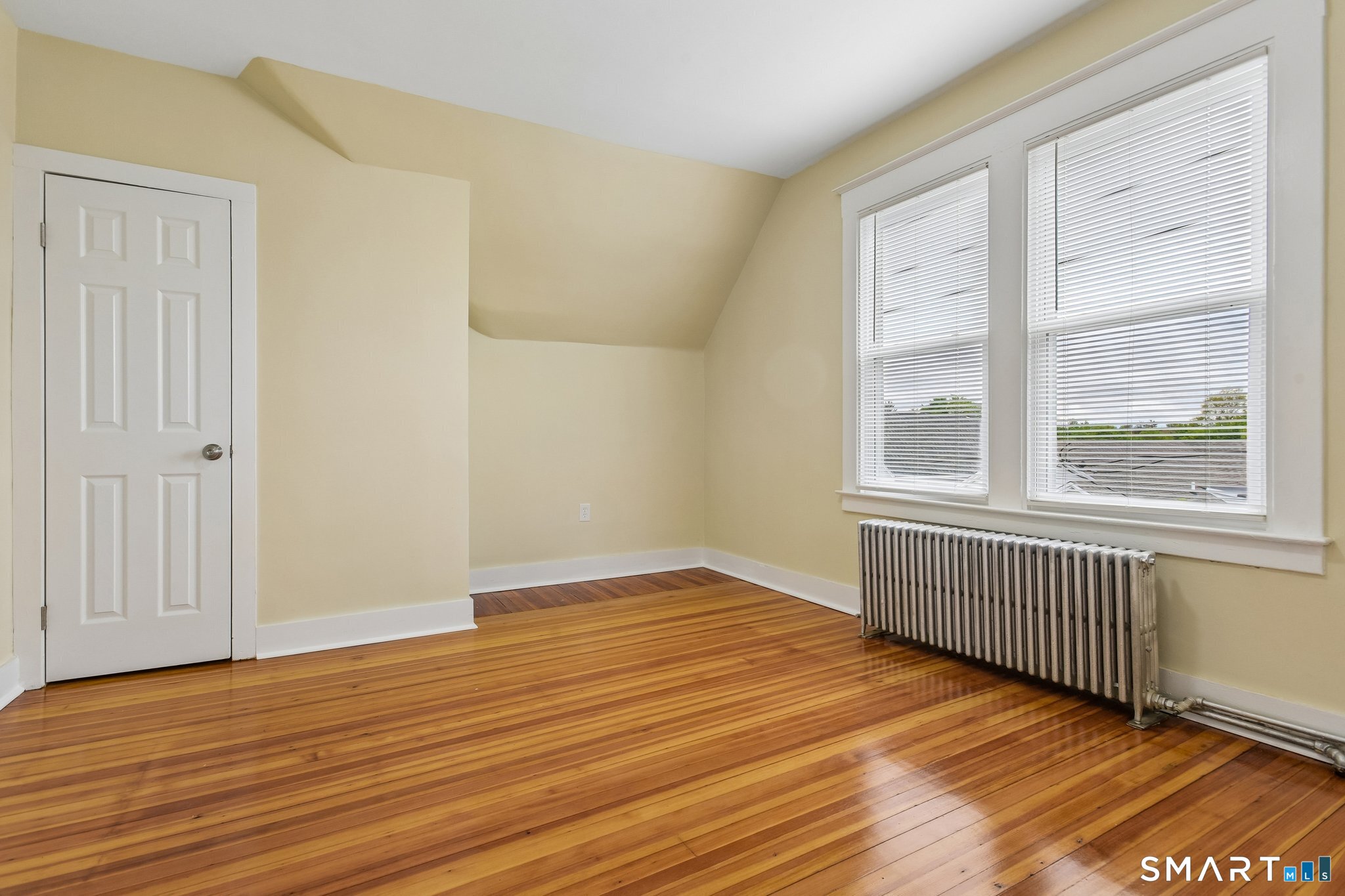 39 Grand Street, Unit 3 Middletown, CT 06457 - Photo 20 of 21 a view of an empty room with wooden floor and a window