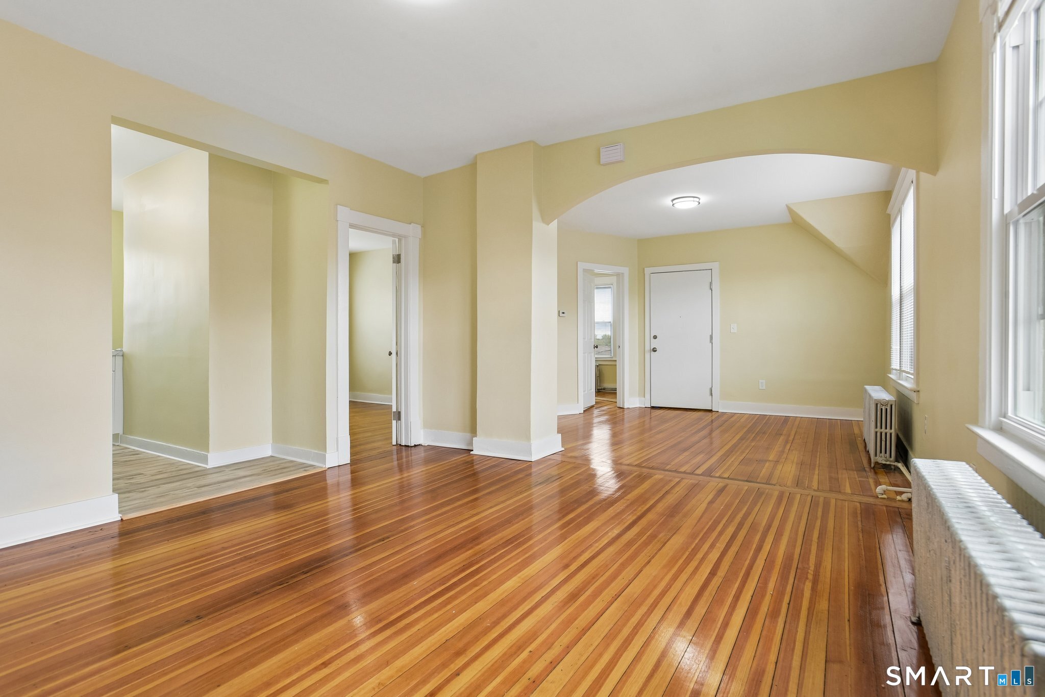 39 Grand Street, Unit 3 Middletown, CT 06457 - Photo 7 of 21 a view of an empty room with wooden floor and a bathroom