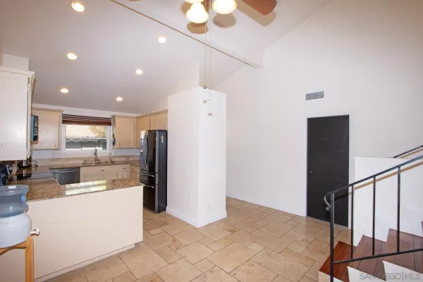 a kitchen with a refrigerator and a sink