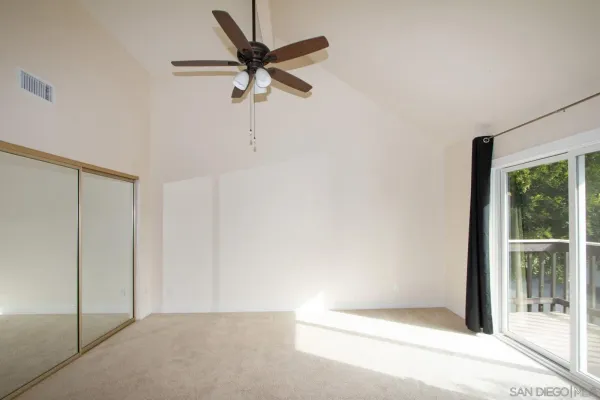 a view of a hallway with a ceiling fan