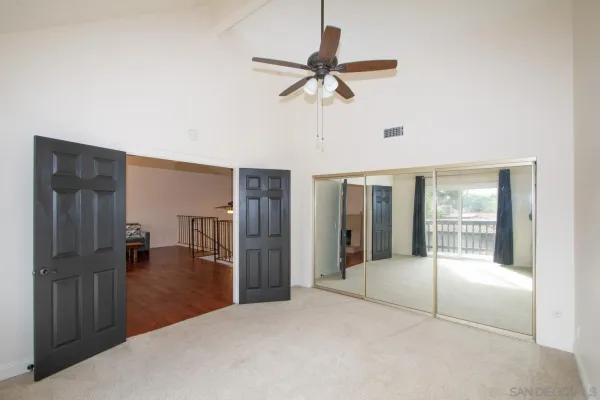 a view of a livingroom with a ceiling fan and window