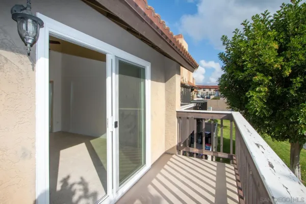 a view of a balcony with yard
