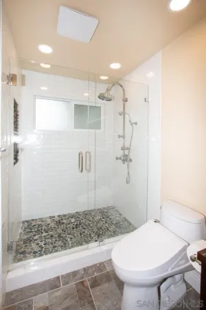 a bedroom with bed and a flat tv screen