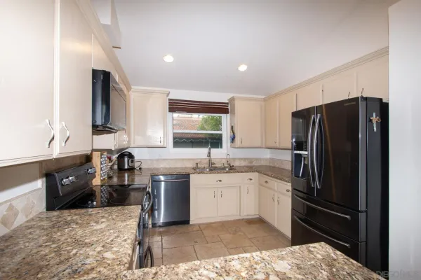a kitchen with a sink stove and refrigerator