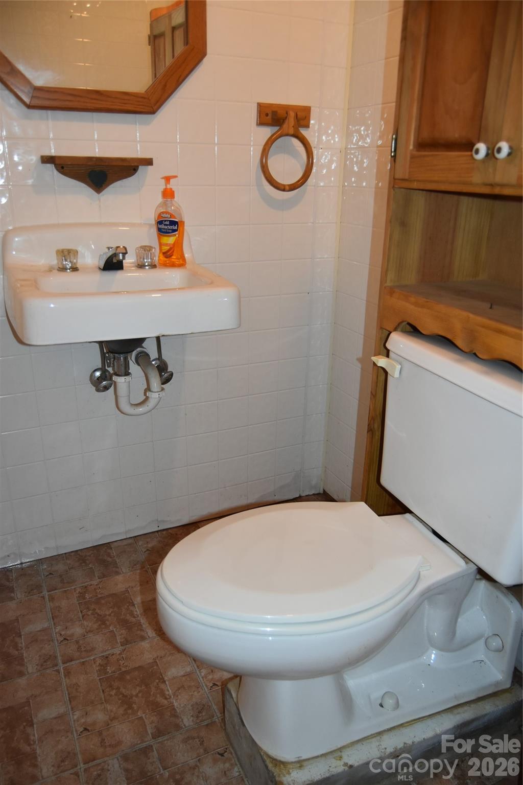 1082 Maple Street Granite Falls, NC 28630 - Photo 14 of 25 a bathroom with a toilet and a sink