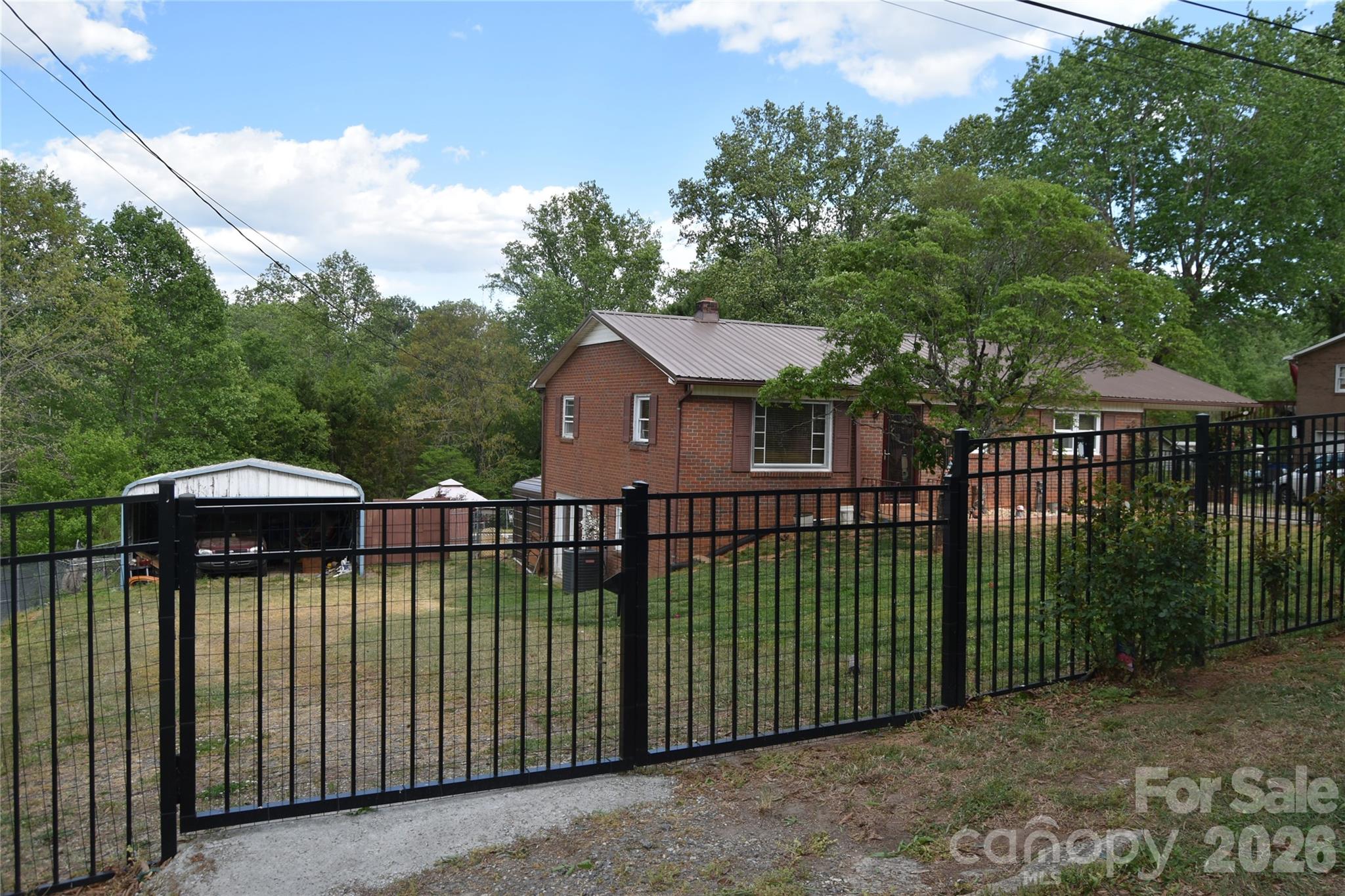 1082 Maple Street Granite Falls, NC 28630 - Photo 5 of 25 a view of a house with backyard and sitting area