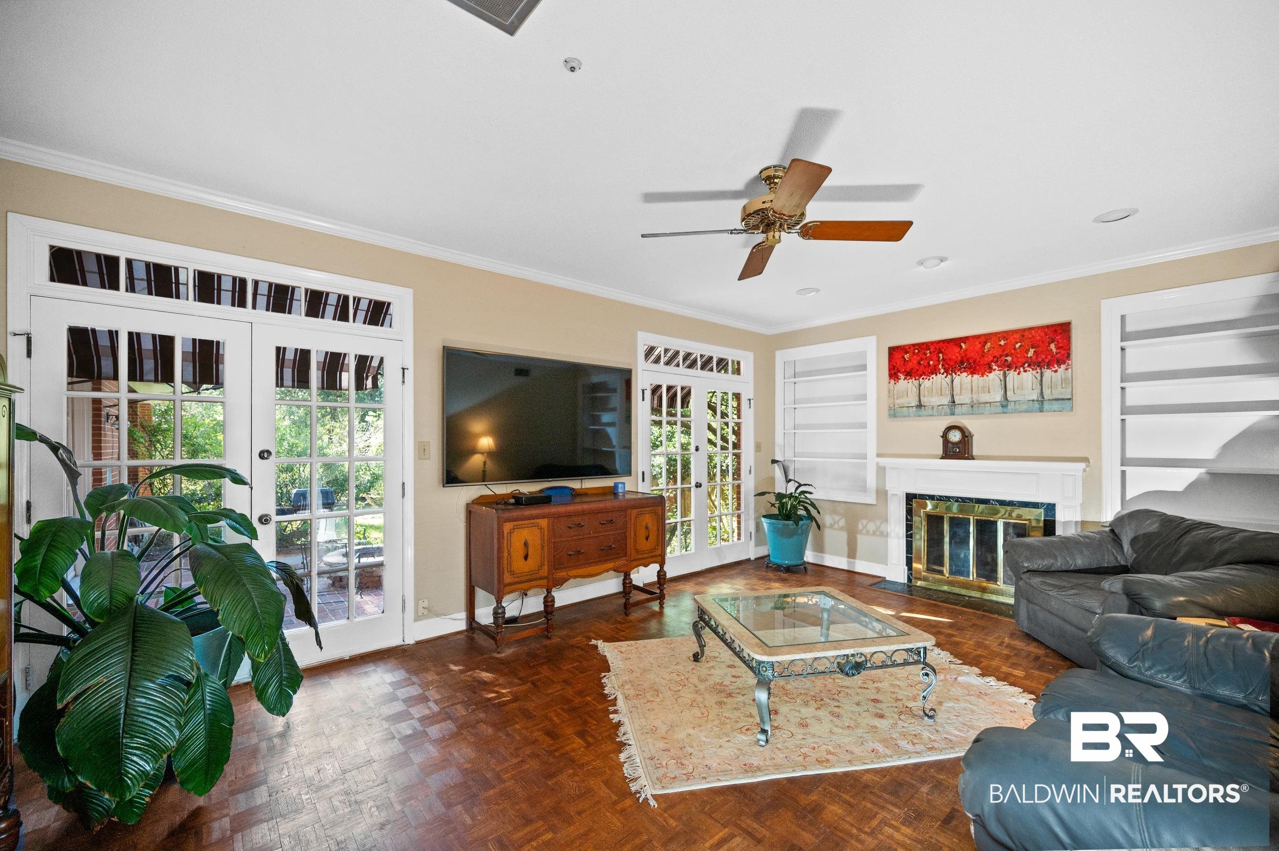 6705 Ridgeland Road South Mobile, AL 36695 - Photo 19 of 44 Living room featuring french doors, dark parquet flooring, crown molding, built in shelves, and ceiling fan