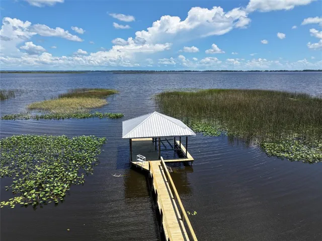 a view of a backyard with sitting area