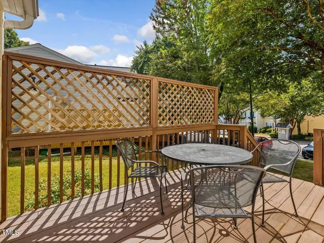 a balcony with table and chairs