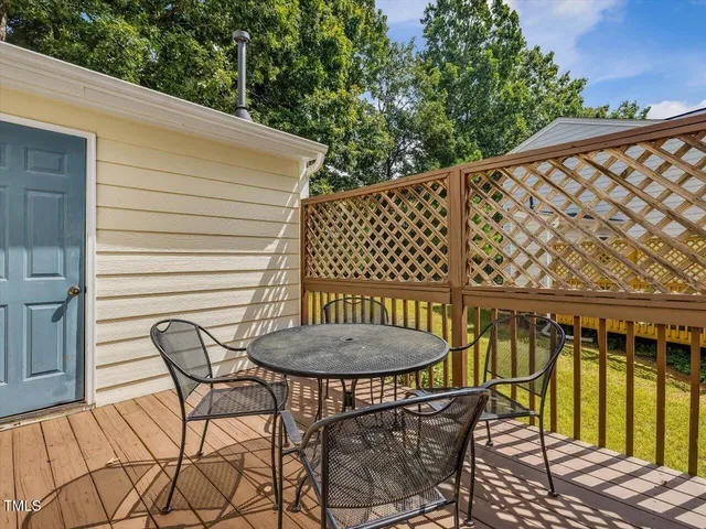 a view of balcony with table and chairs