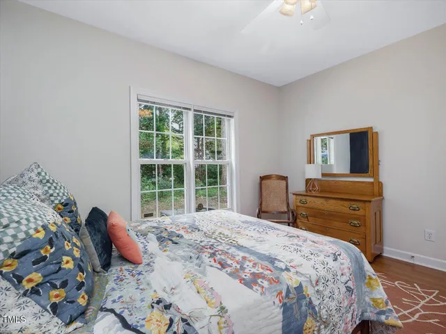 a bedroom with a bed and a painting on the wall