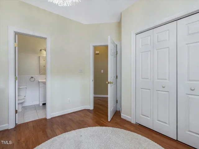 a view of staircase with wooden floor and a chandelier