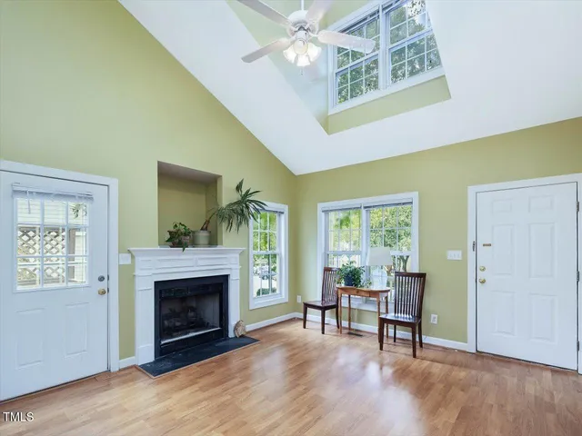 a living room with a fireplace with windows