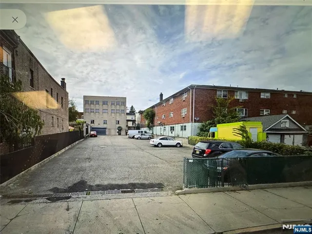 a kitchen with kitchen island wooden floors appliances and a sink