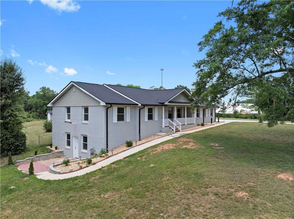 5245 Stonewall Tell Road Atlanta, GA 30349 - Photo 3 of 15 a view of a house with a yard