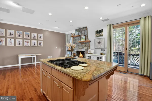 a kitchen island with a stove and wooden floor