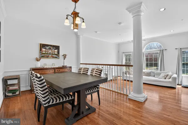 a view of a dining room with furniture wooden floor and chandelier