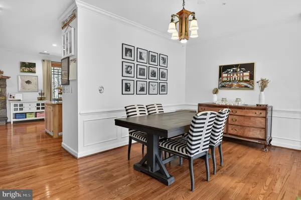 a view of a dining room with furniture wooden floor and chandelier