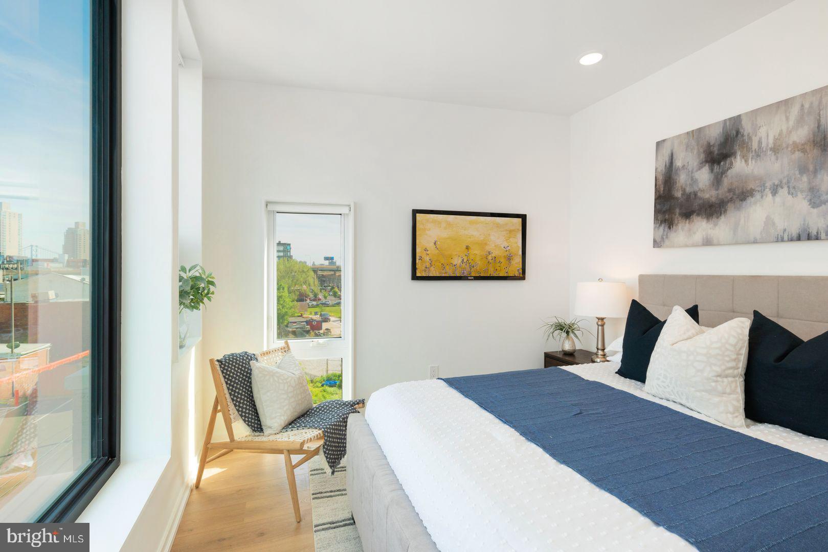 1141 North Front Street, Unit 307 Philadelphia, PA 19123 - Photo 13 of 28 a bedroom with a bed and a painting on the wall