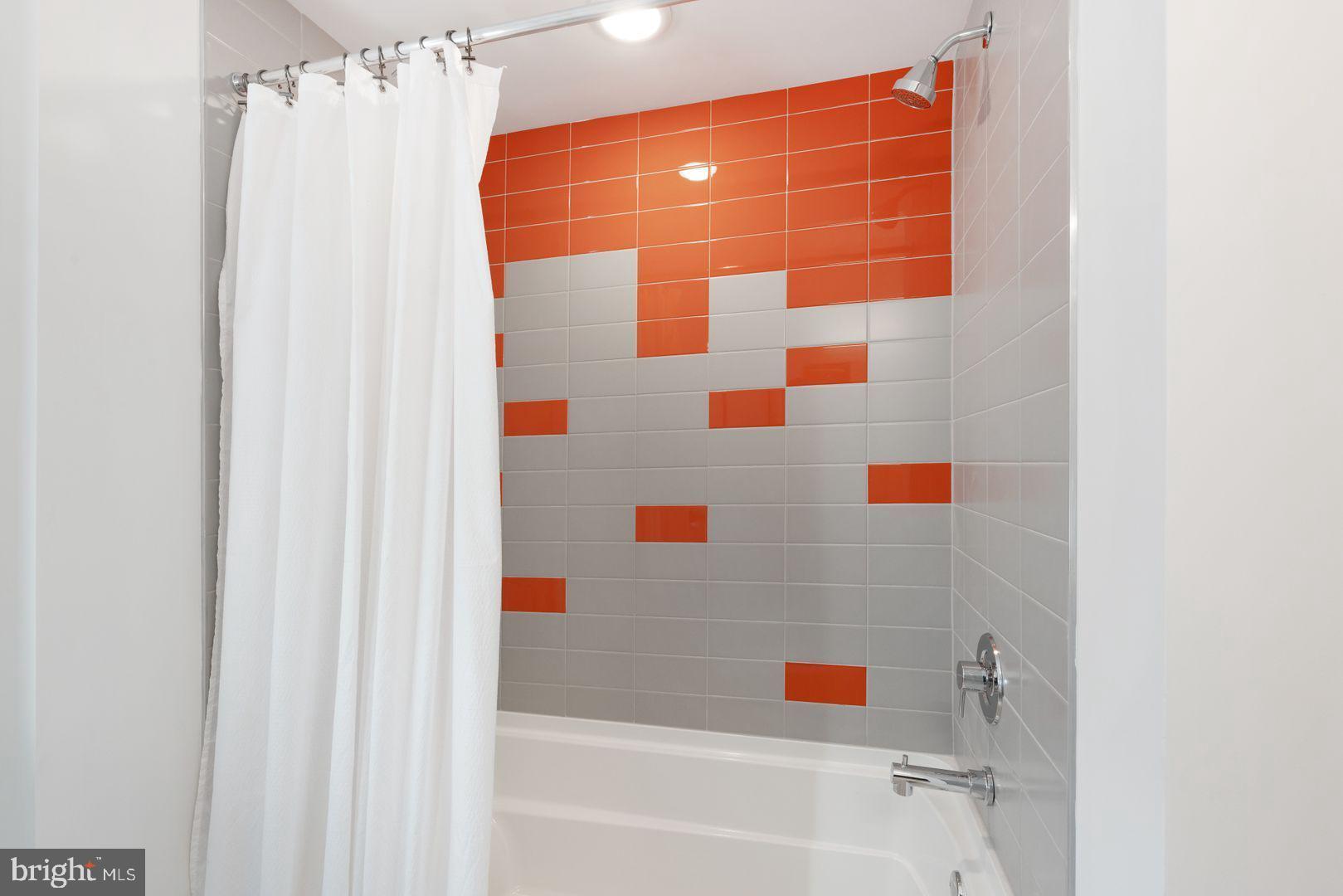 1141 North Front Street, Unit 307 Philadelphia, PA 19123 - Photo 16 of 28 a bathroom with a bathtub and shower