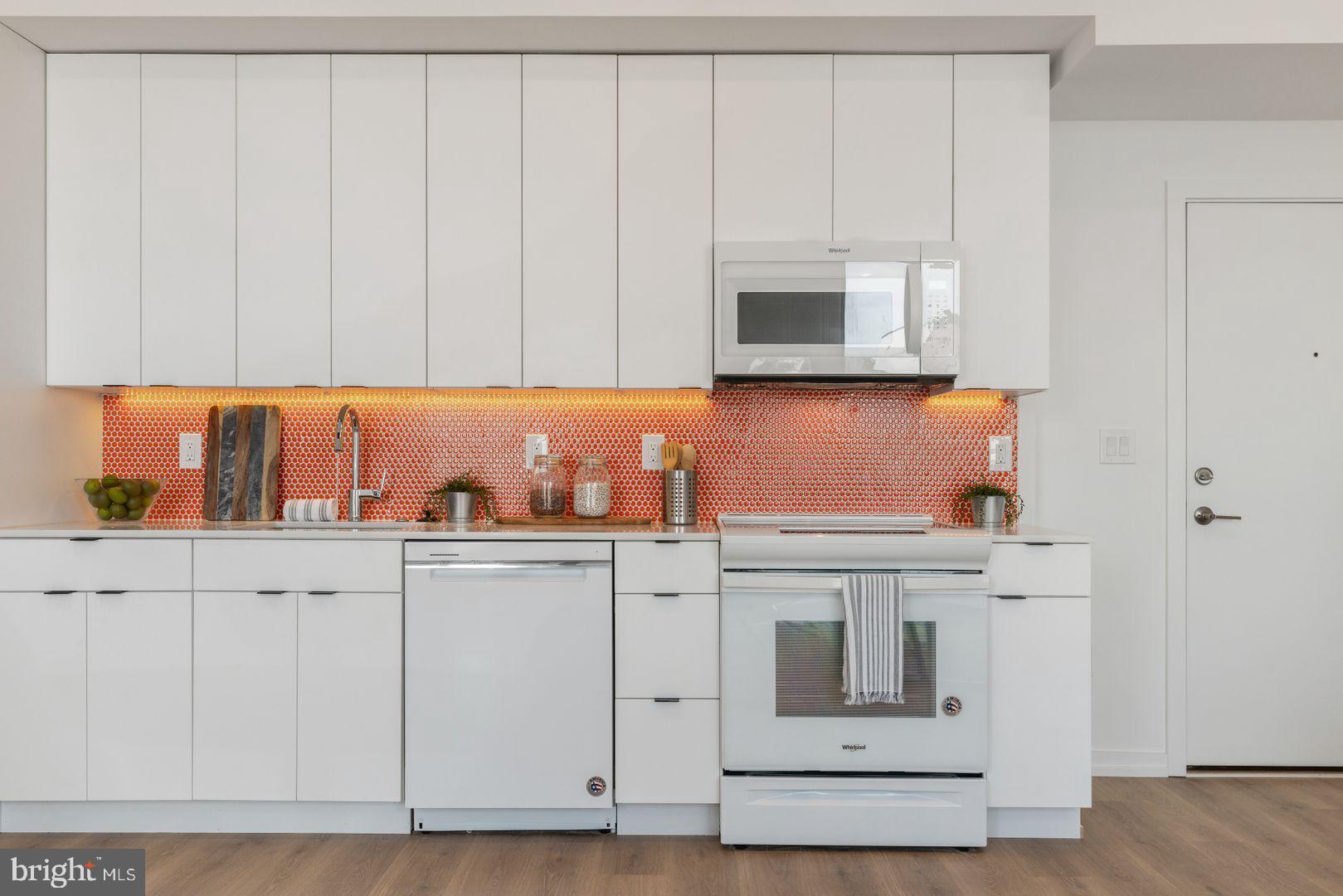 1141 North Front Street, Unit 307 Philadelphia, PA 19123 - Photo 10 of 28 a kitchen with white cabinets and white appliances