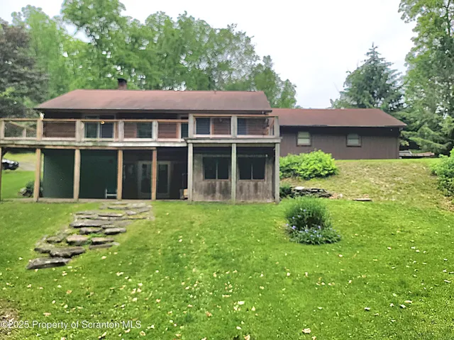 a view of a house with yard and sitting area