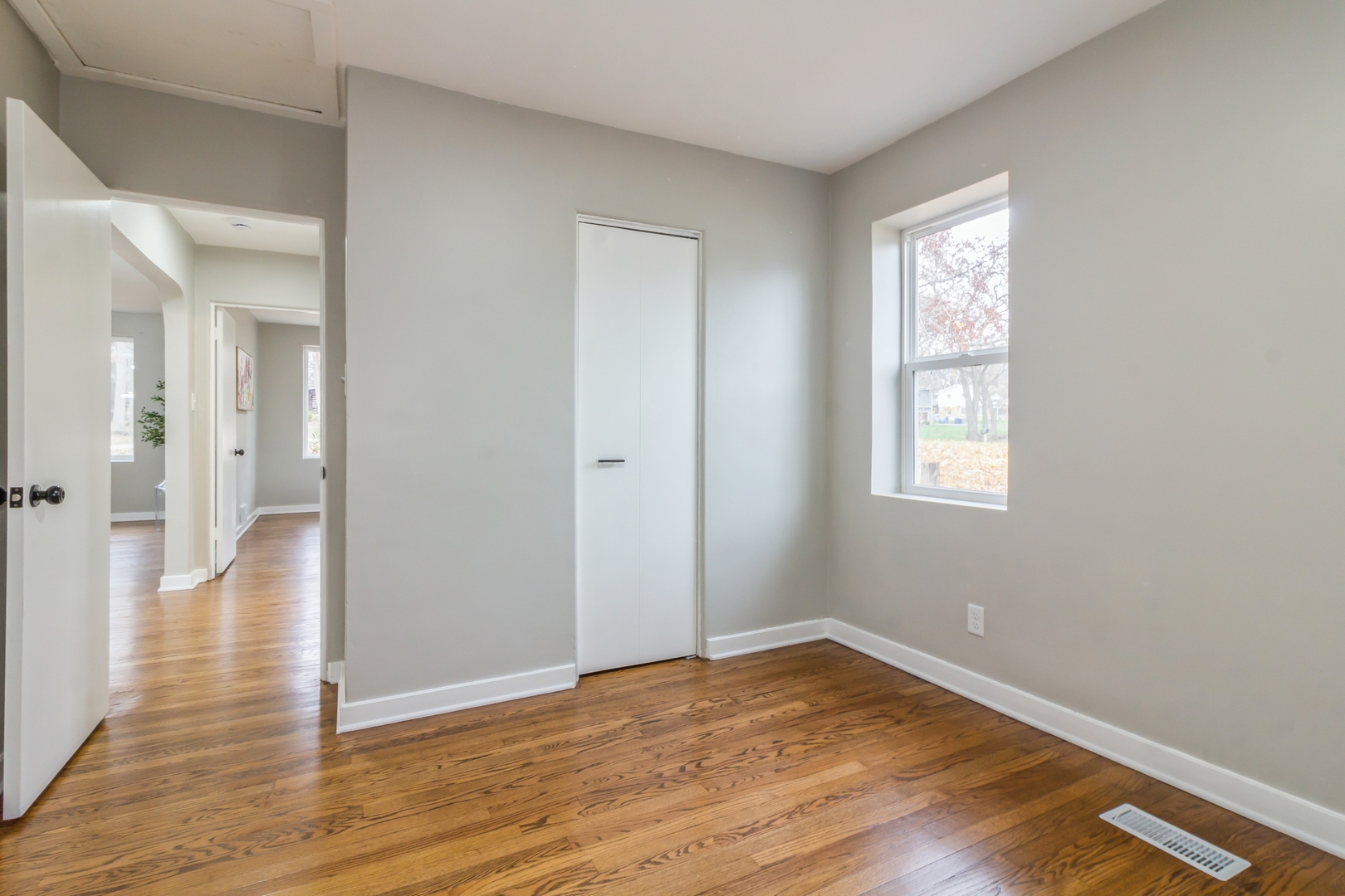 11 Vale Road West Chicago, IL 60185 - Photo 5 of 15 an empty room with wooden floor and windows