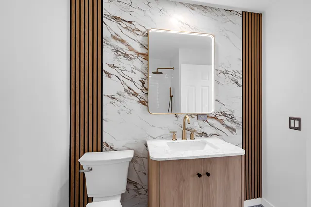 a bedroom with a large bed and a potted plant