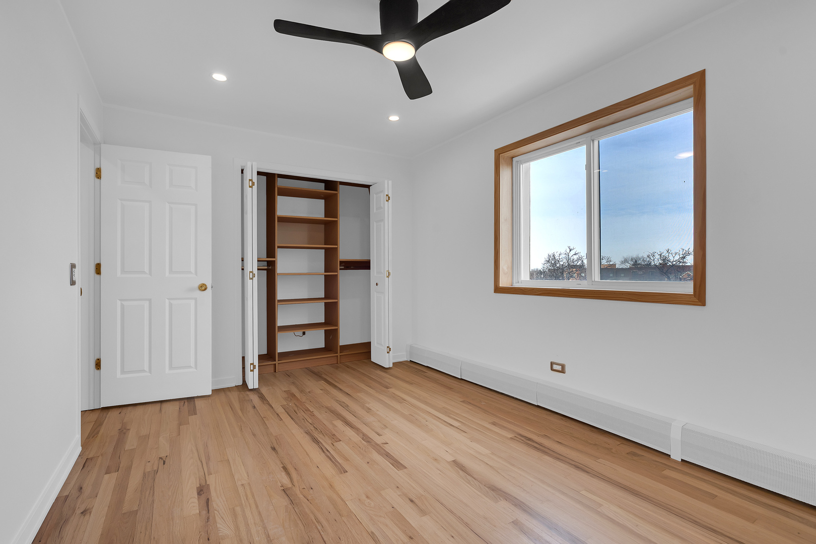 4976 North Milwaukee Avenue, Unit 401 Chicago, IL 60630 - Photo 17 of 23 wooden floor in an empty room with a window