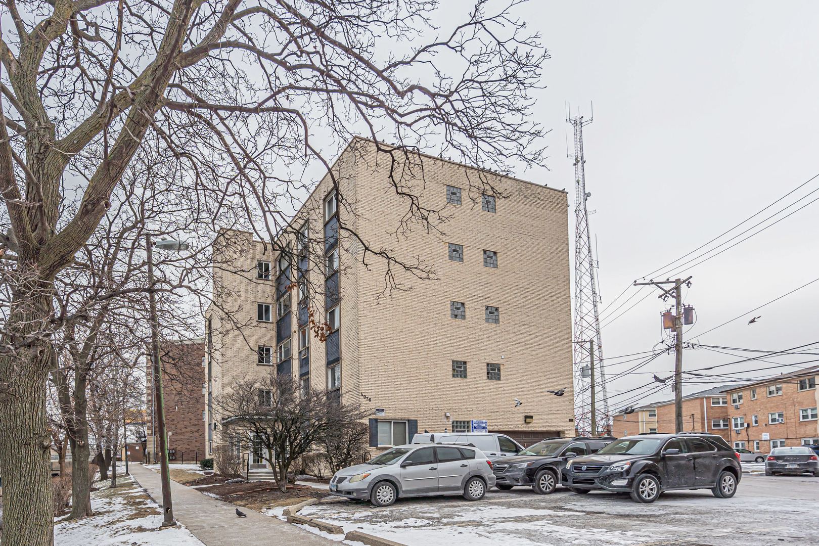 4976 North Milwaukee Avenue, Unit 401 Chicago, IL 60630 - Photo 23 of 23 a street view with tall buildings