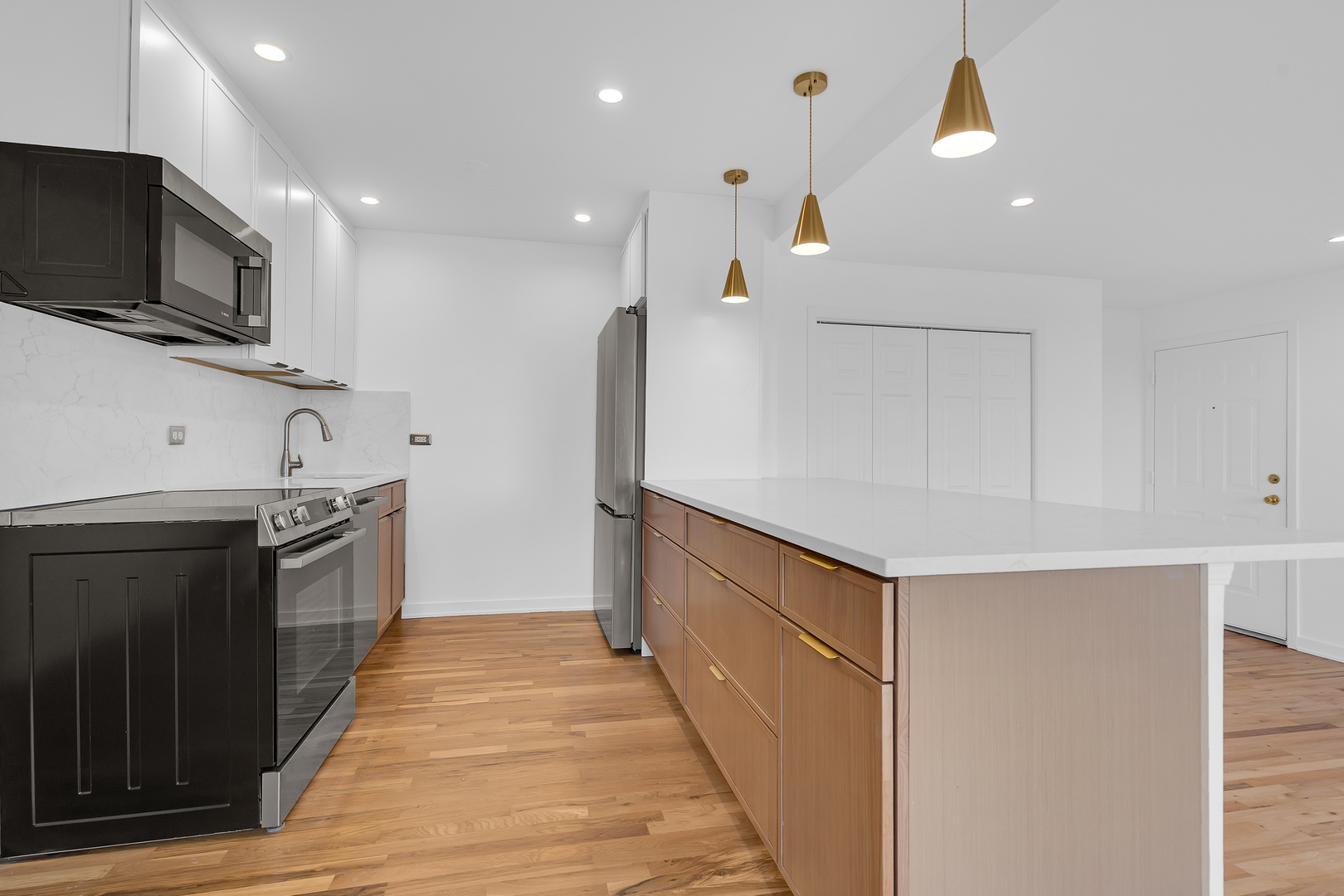 4976 North Milwaukee Avenue, Unit 401 Chicago, IL 60630 - Photo 9 of 23 a kitchen with stainless steel appliances a stove top oven a sink dishwasher a refrigerator and a microwave