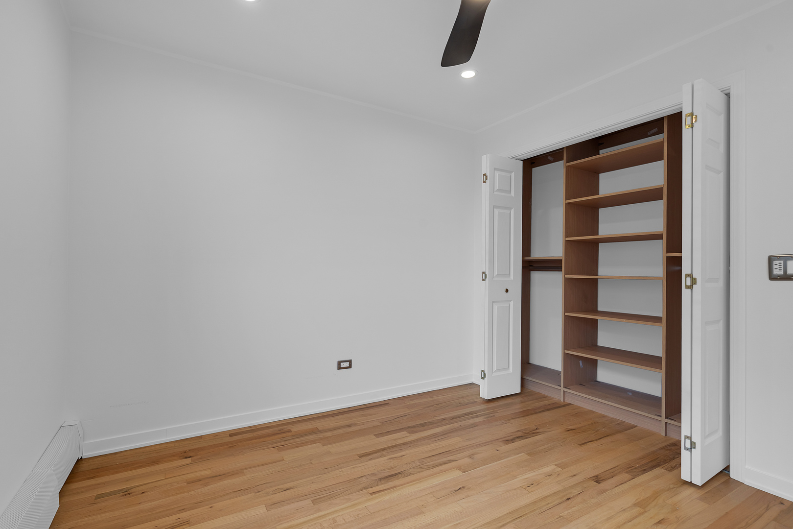 4976 North Milwaukee Avenue, Unit 401 Chicago, IL 60630 - Photo 10 of 23 a view of an empty room with a window and wooden floor