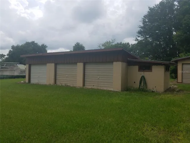 a backyard of a house with table and chairs