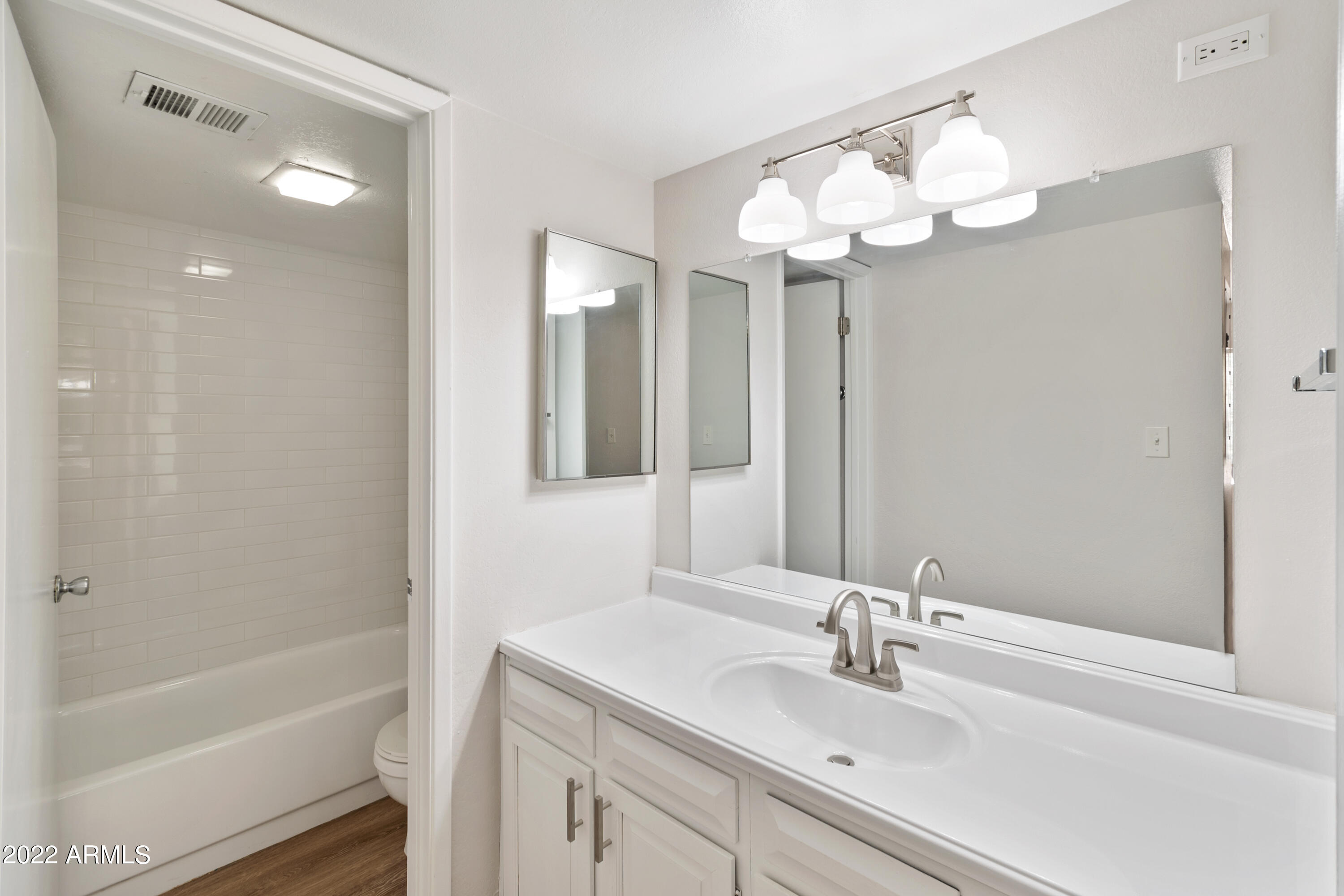 2044 South Rural Road, Unit B Tempe, AZ 85282 - Photo 5 of 16 a bathroom with a sink vanity tub and a mirror