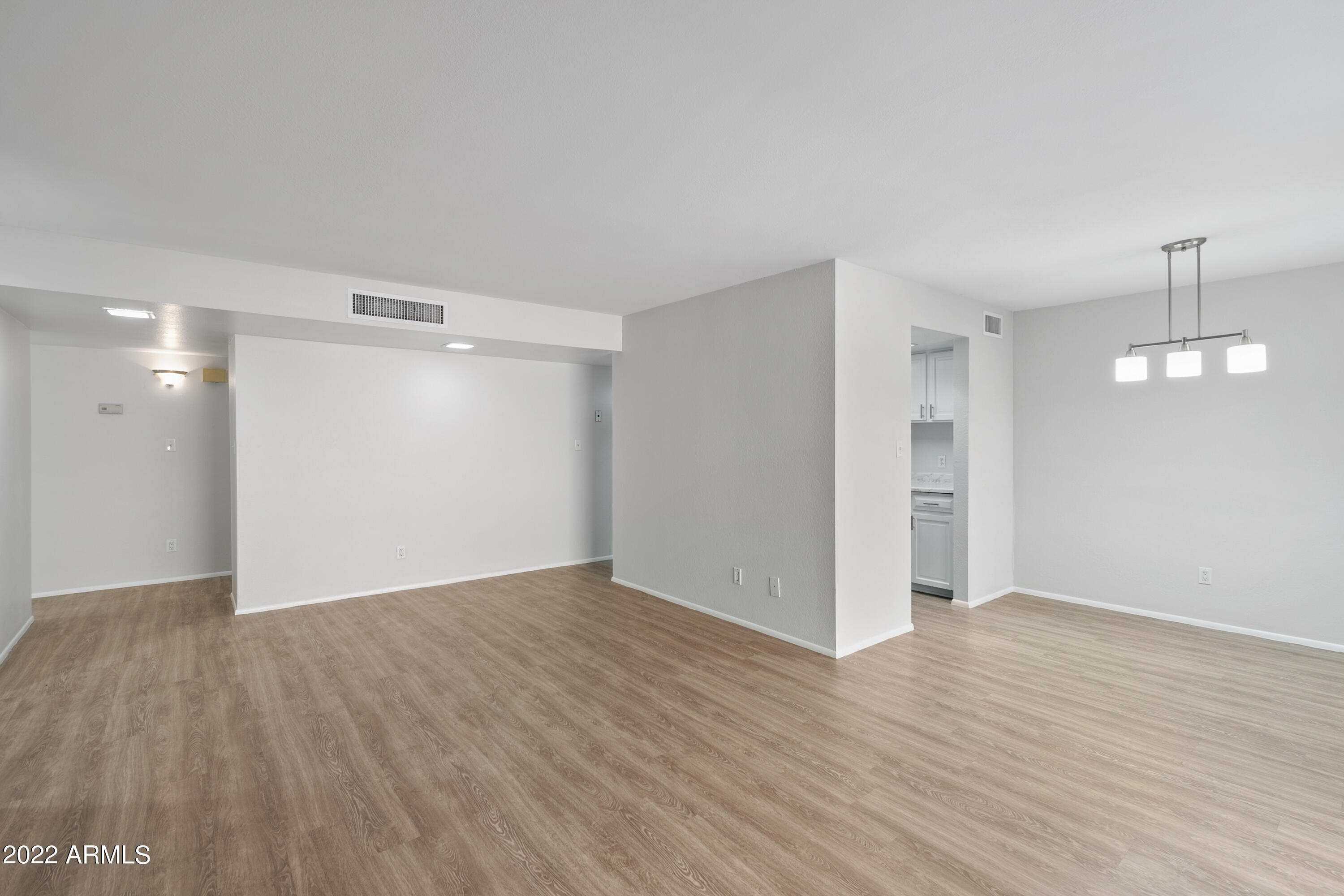 2044 South Rural Road, Unit B Tempe, AZ 85282 - Photo 6 of 16 a view of an empty room with wooden floor