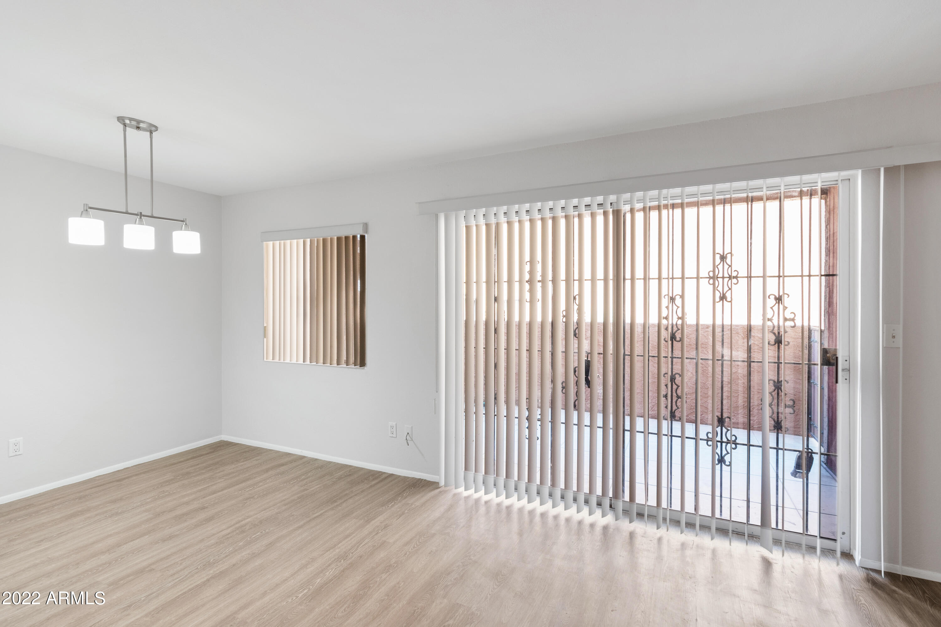 2044 South Rural Road, Unit B Tempe, AZ 85282 - Photo 7 of 16 a view of empty room with wooden floor and fan