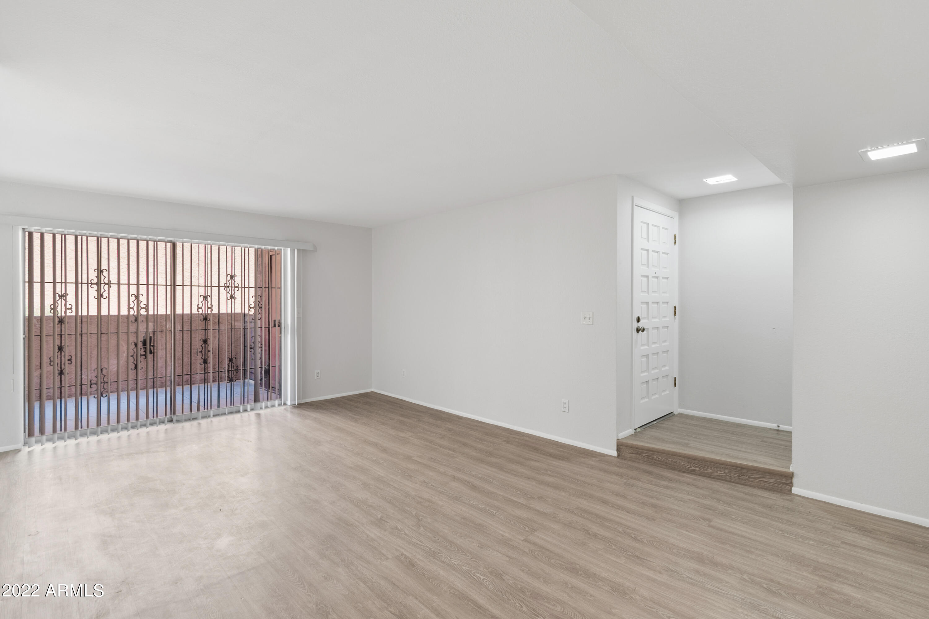 2044 South Rural Road, Unit B Tempe, AZ 85282 - Photo 10 of 16 a view of an empty room with wooden floor