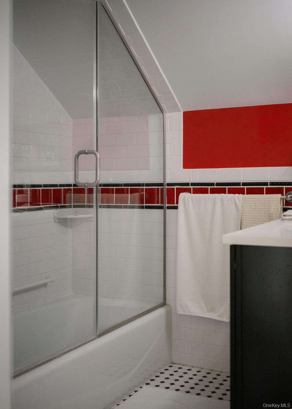 92 Fiddlers Bridge Road Staatsburg, NY 12580 - Photo 12 of 32 Bathroom featuring a glass-enclosed tub/shower combination with white subway tile surround, a built-in shower shelf, and black and white mosaic floor tile