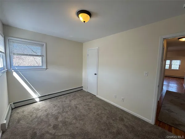 an empty room with windows and closet