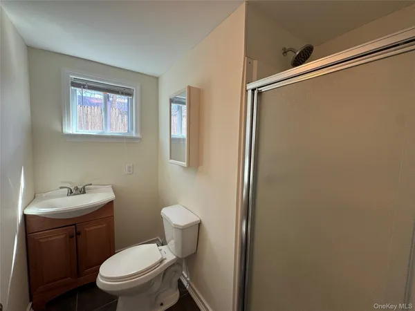 a white toilet sitting next to a bathroom sink