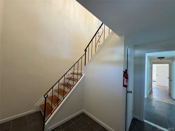 a view of entryway and hall with wooden floor